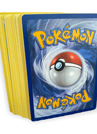Stack of Pokémon trading cards with a prominent Poké Ball design on the front card.